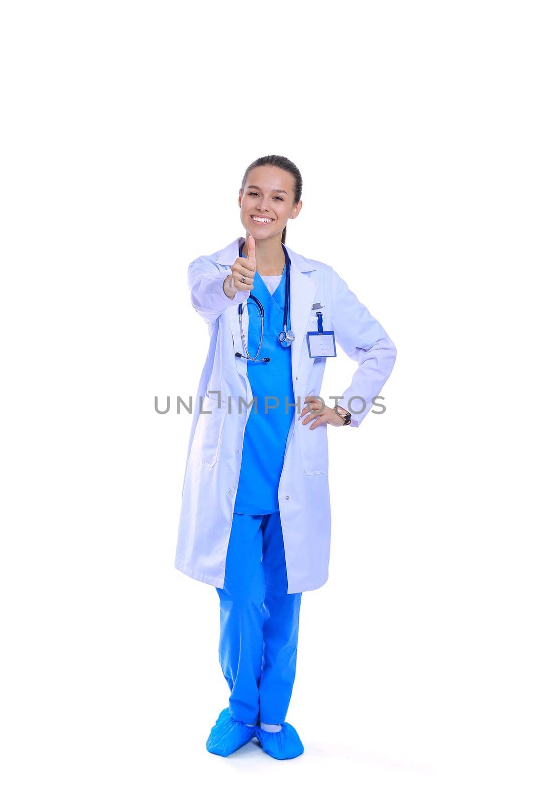 Beautiful young woman in white coat posing with hand in pocket. Woman doctor by lenetstan