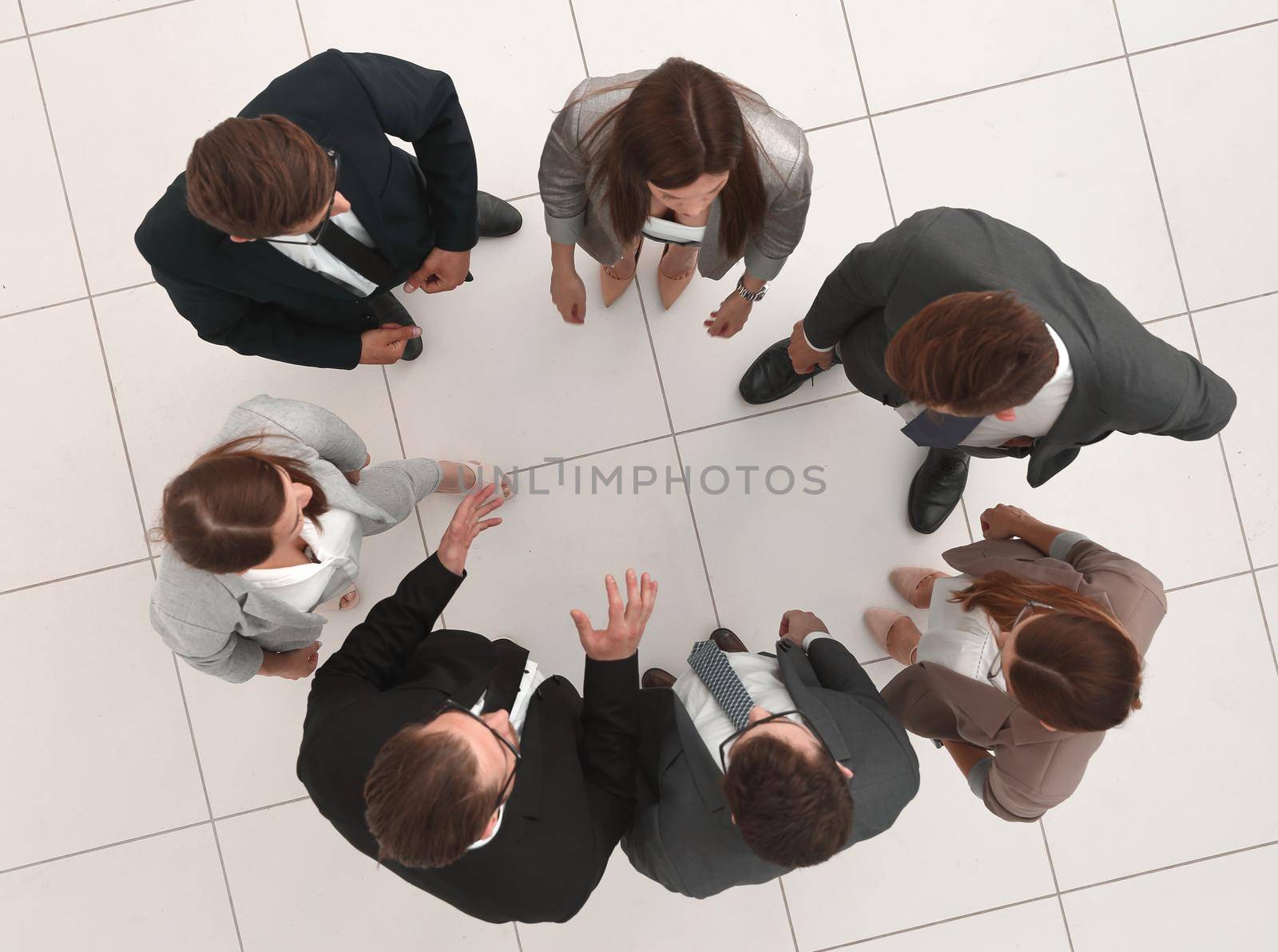 top view.business team talking standing in a circle.the concept of teamwork