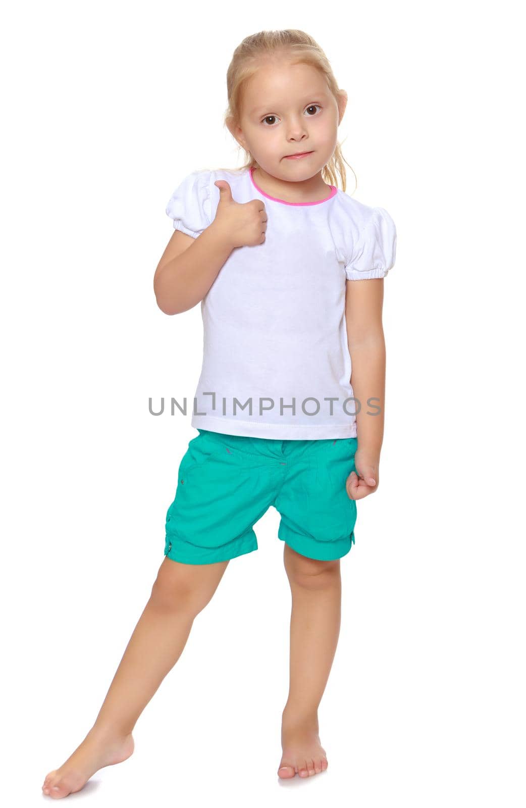 Cute little blond girl in white tank top without a pattern.Girl shows thumb to the side.Isolated on white background