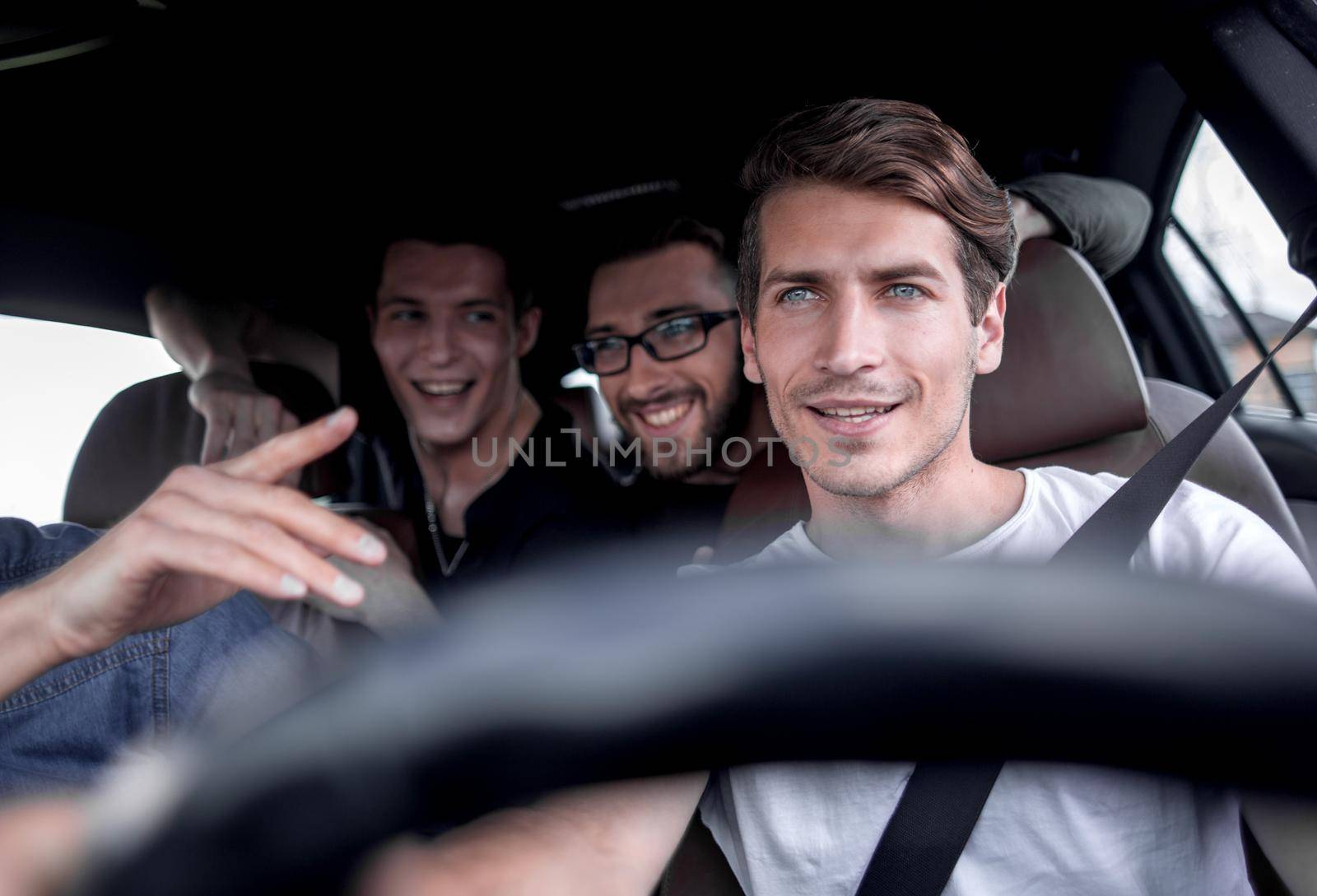 A group of people inside a car, on a road trip by asdf