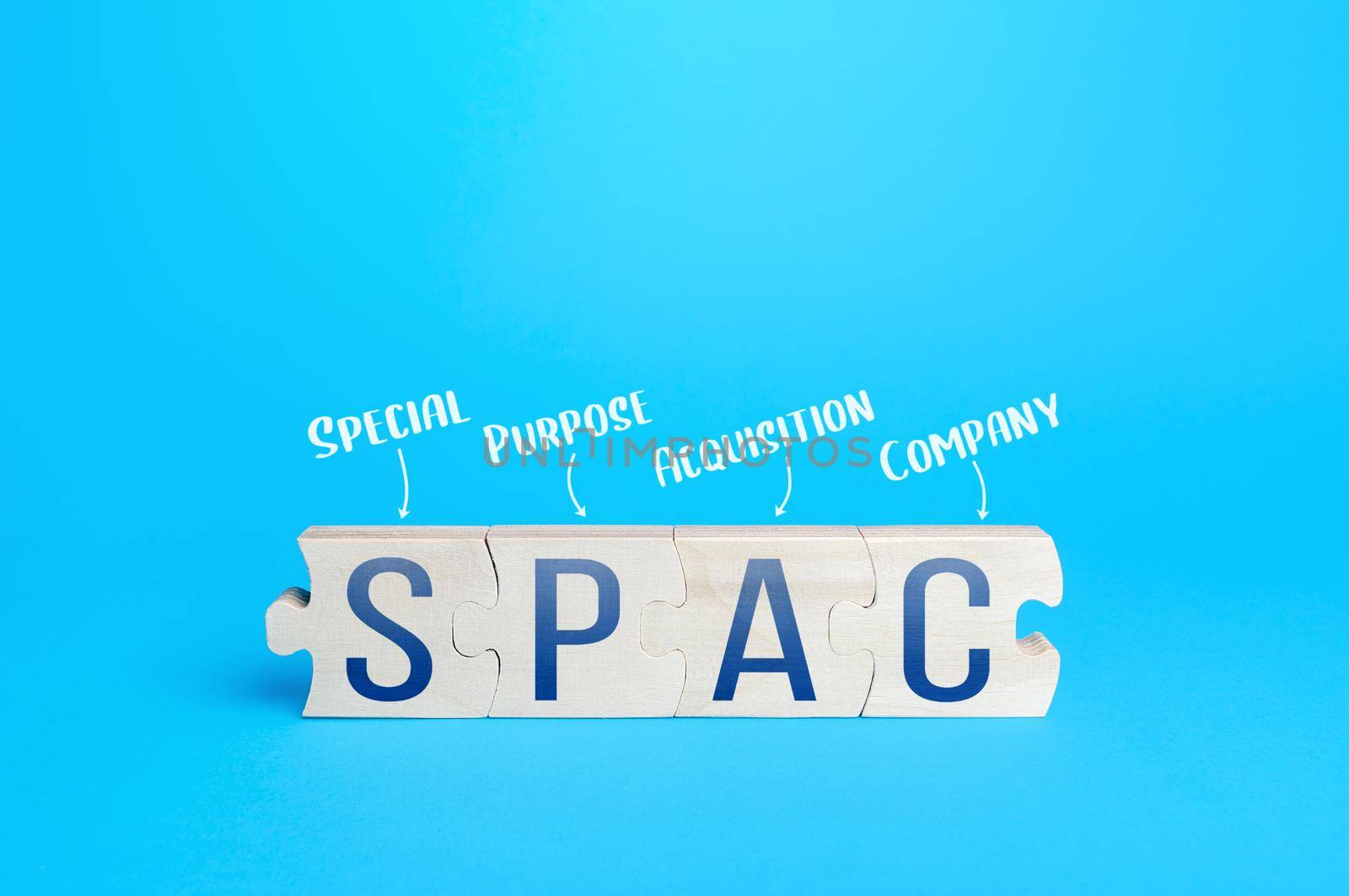 Wooden puzzle blocks with abbreviation SPAC (Special purpose acquisition company). Simplified listing of company, merger bypassing stock exchange IPO. Assessment of benefits and risks of investments