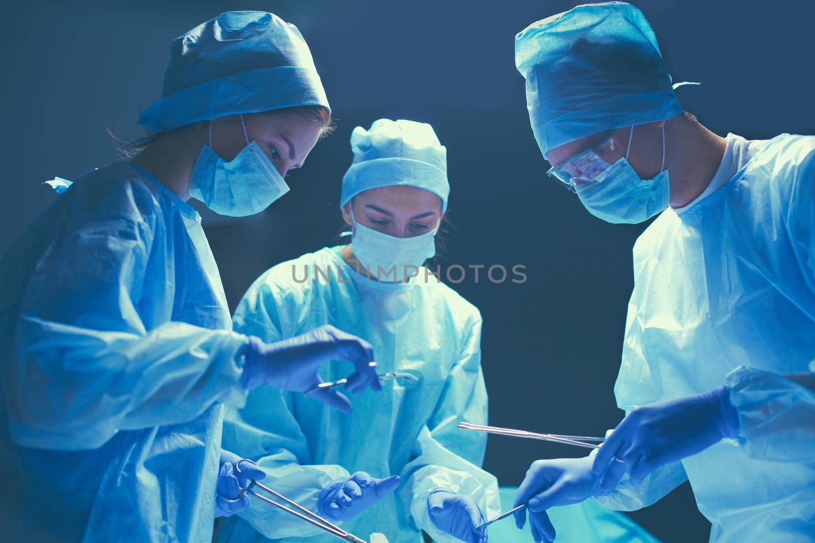 Team surgeon at work in operating room by lenetstan