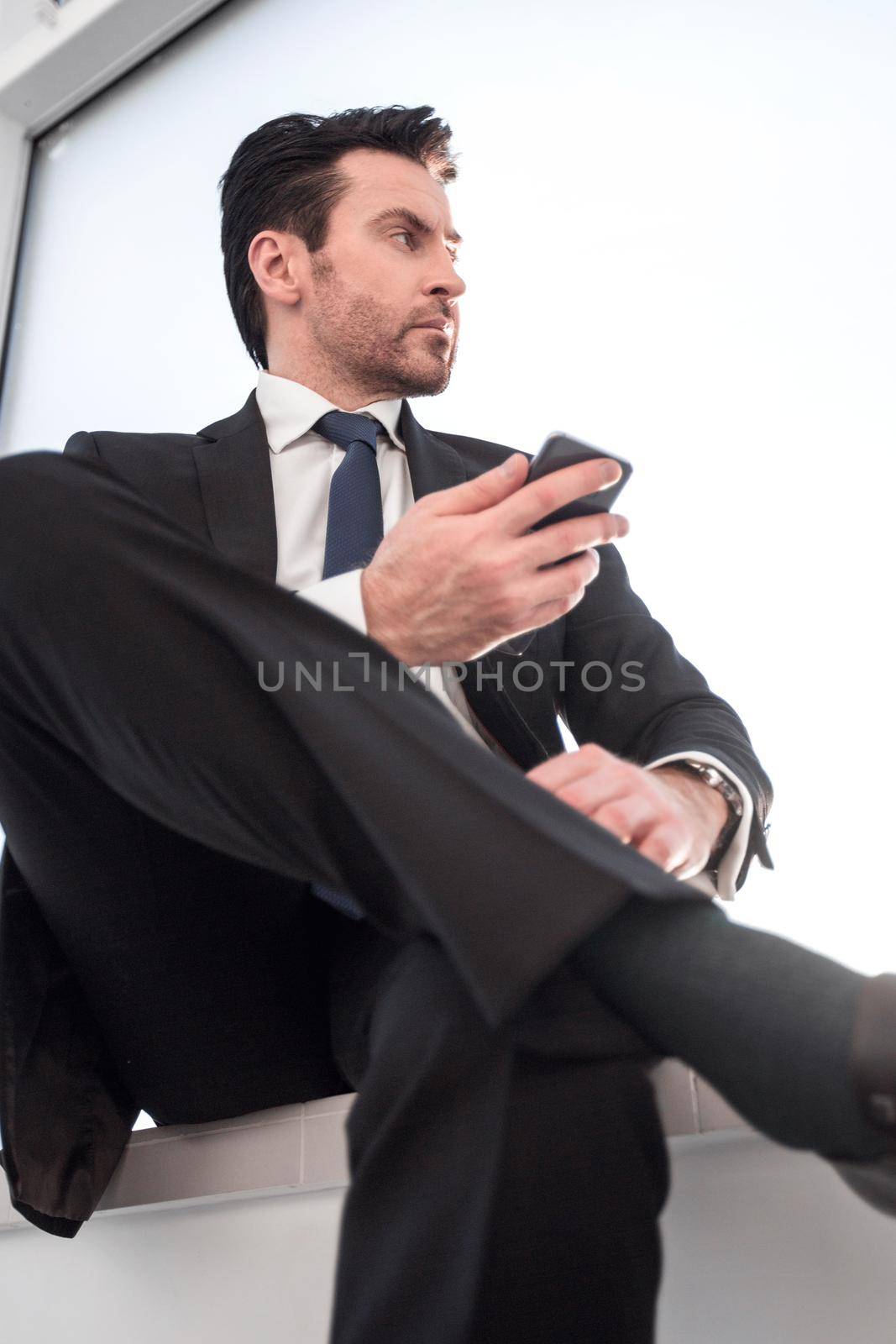 businessman typing SMS on his smartphone. business and technology