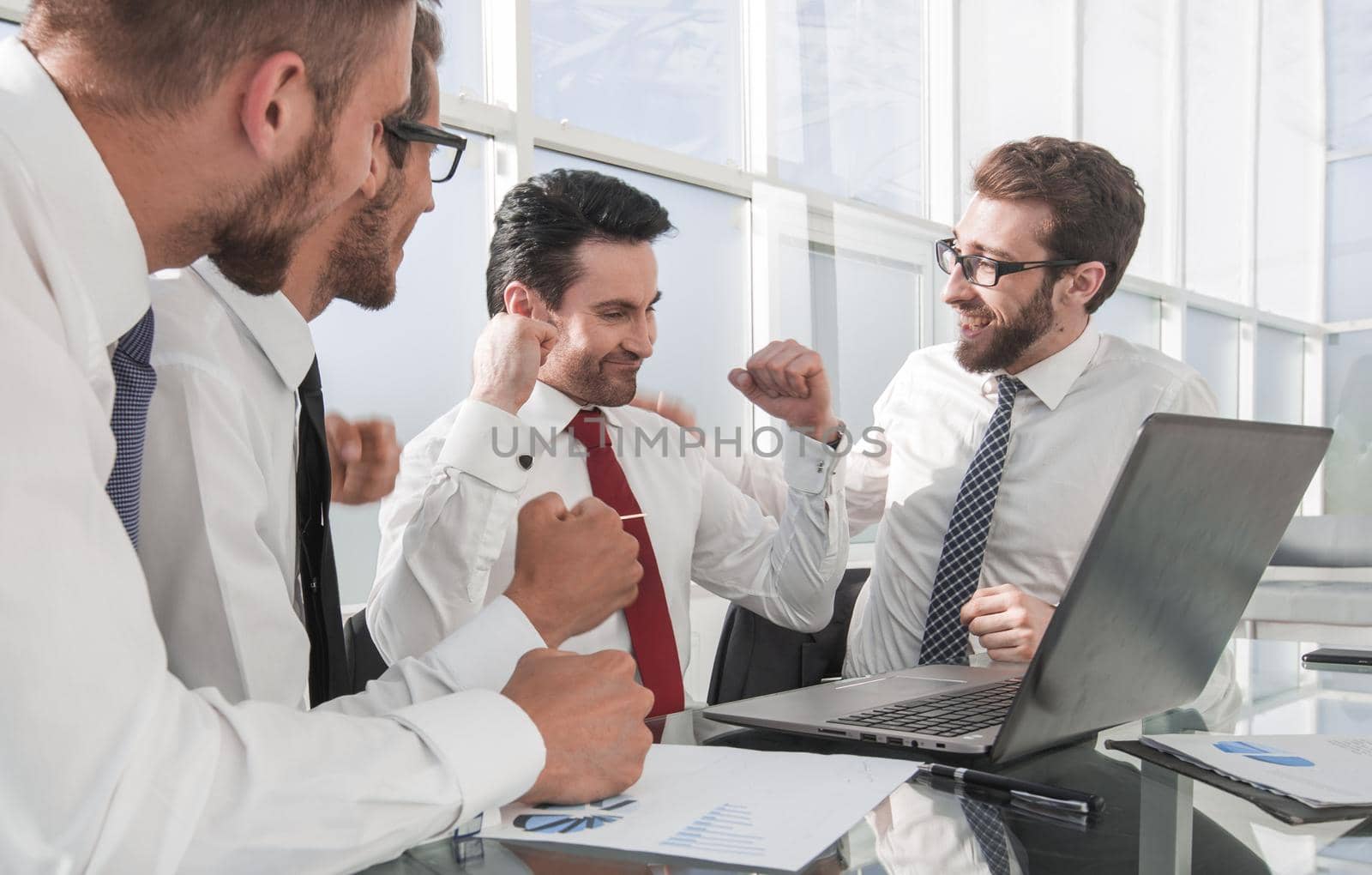 happy business team sitting at the Desk .the concept of teamwork