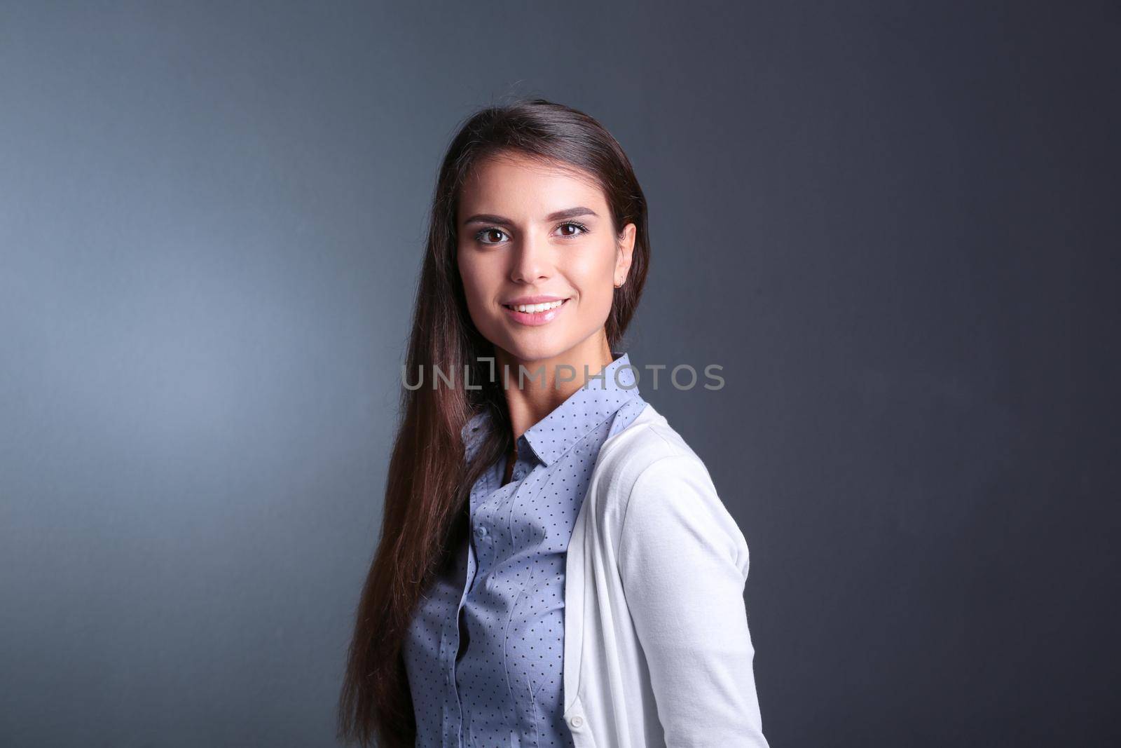 Portrait of a businesswoman , against dark background. Woman smiling. Portrait of a woman by lenetstan