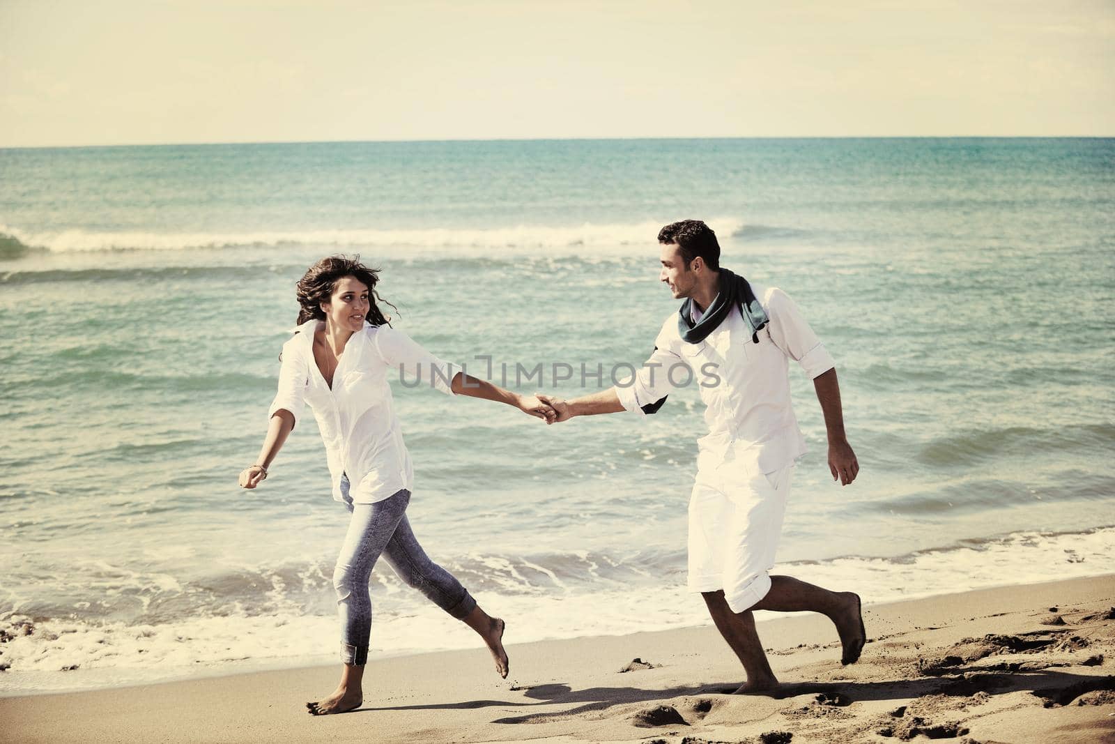 happy young couple in white clothing  have romantic recreation and   fun at beautiful beach on  vacations