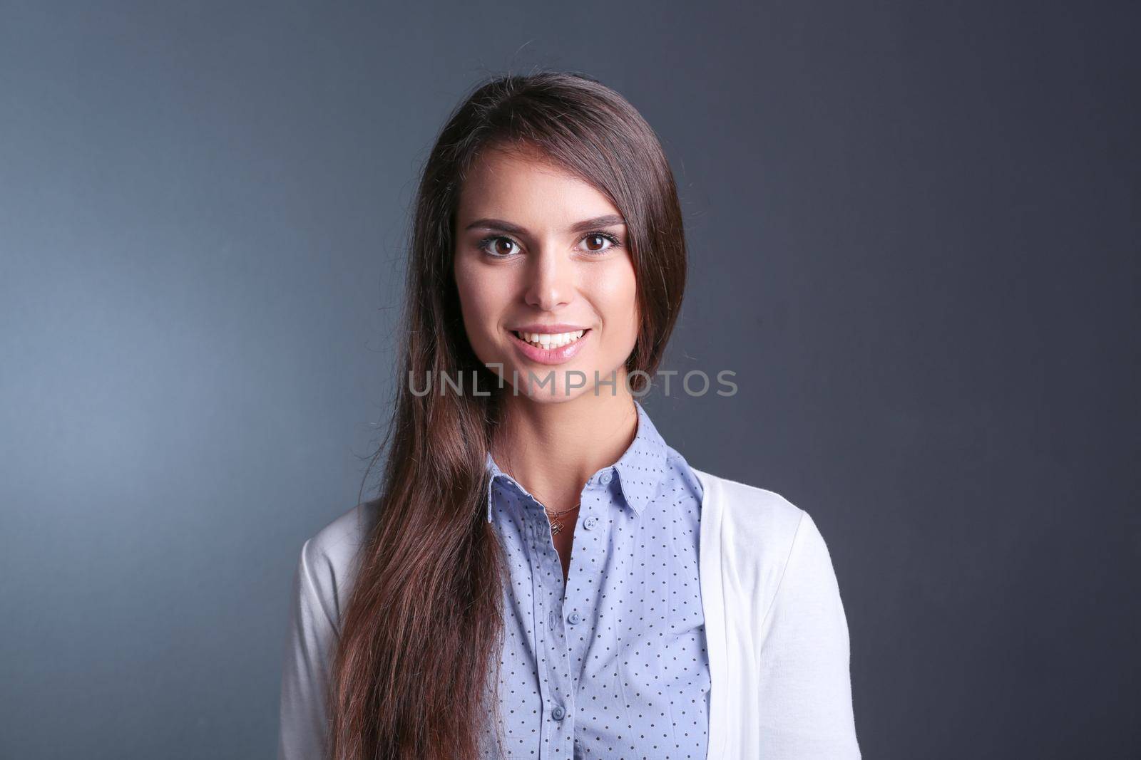 Portrait of a businesswoman , against dark background. Woman smiling. Portrait of a woman by lenetstan