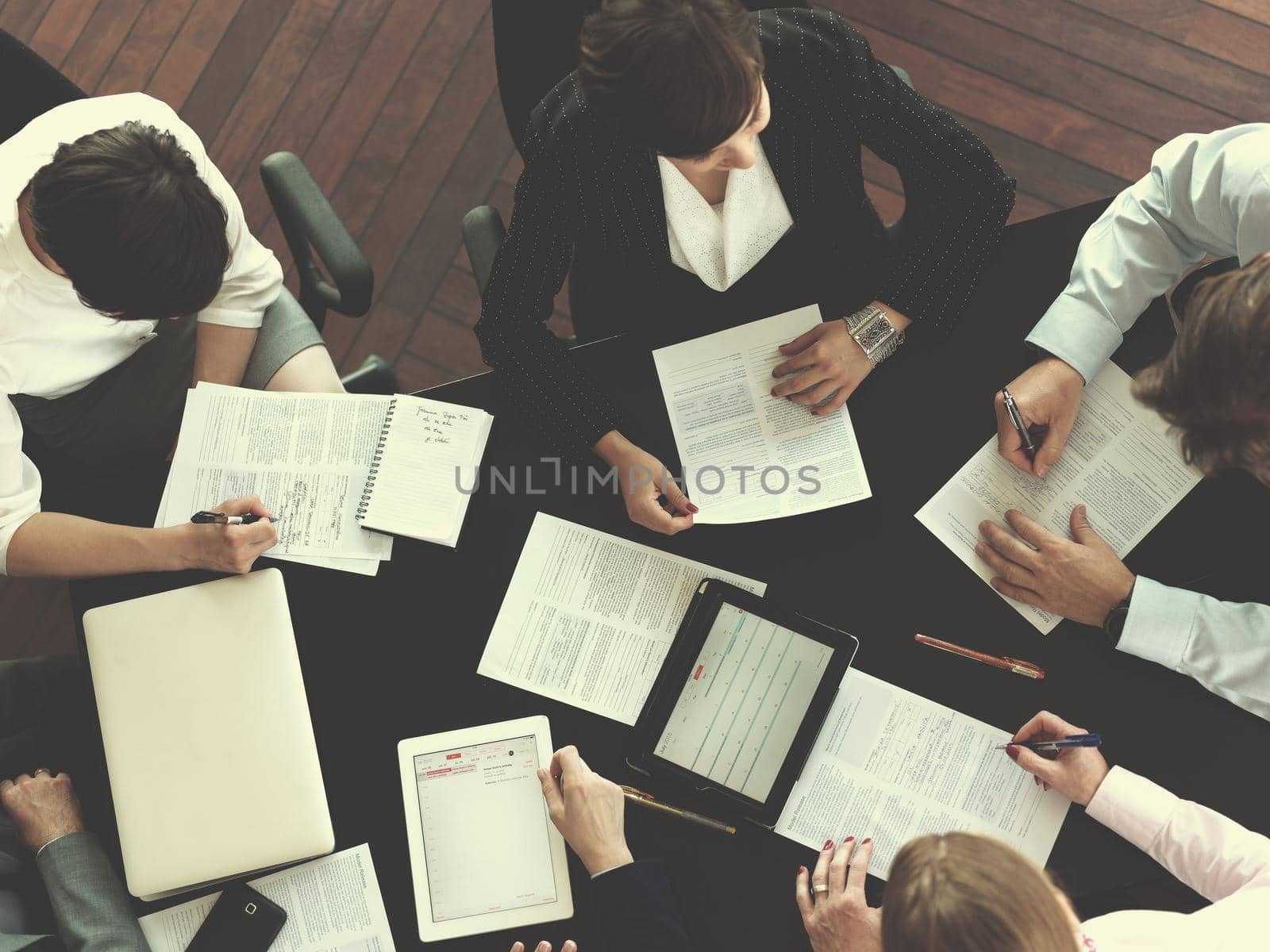 top view of  business people group on meeting, working in modern bright office indoor with tablet computer