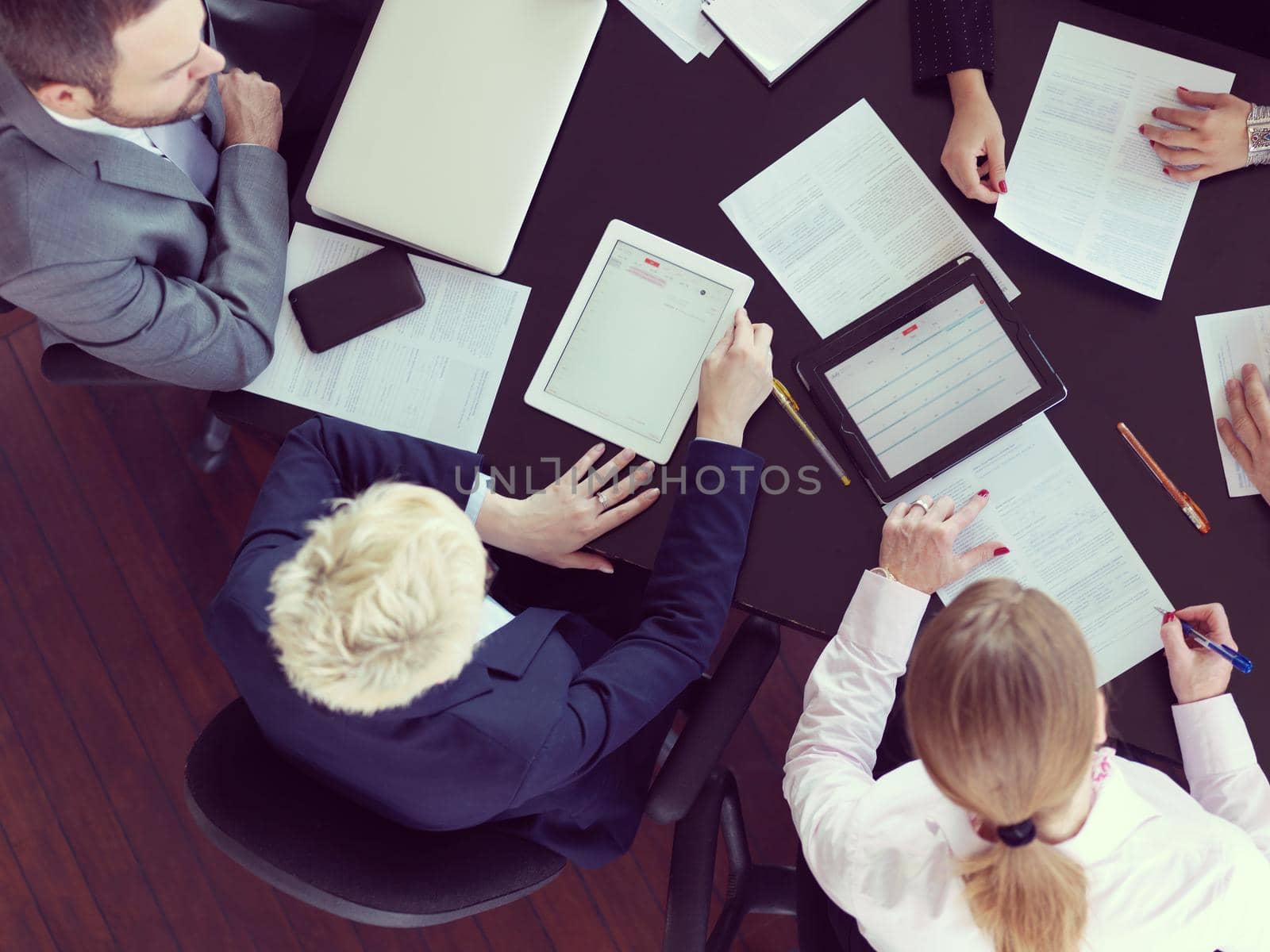 top view of  business people group on meeting, working in modern bright office indoor with tablet computer