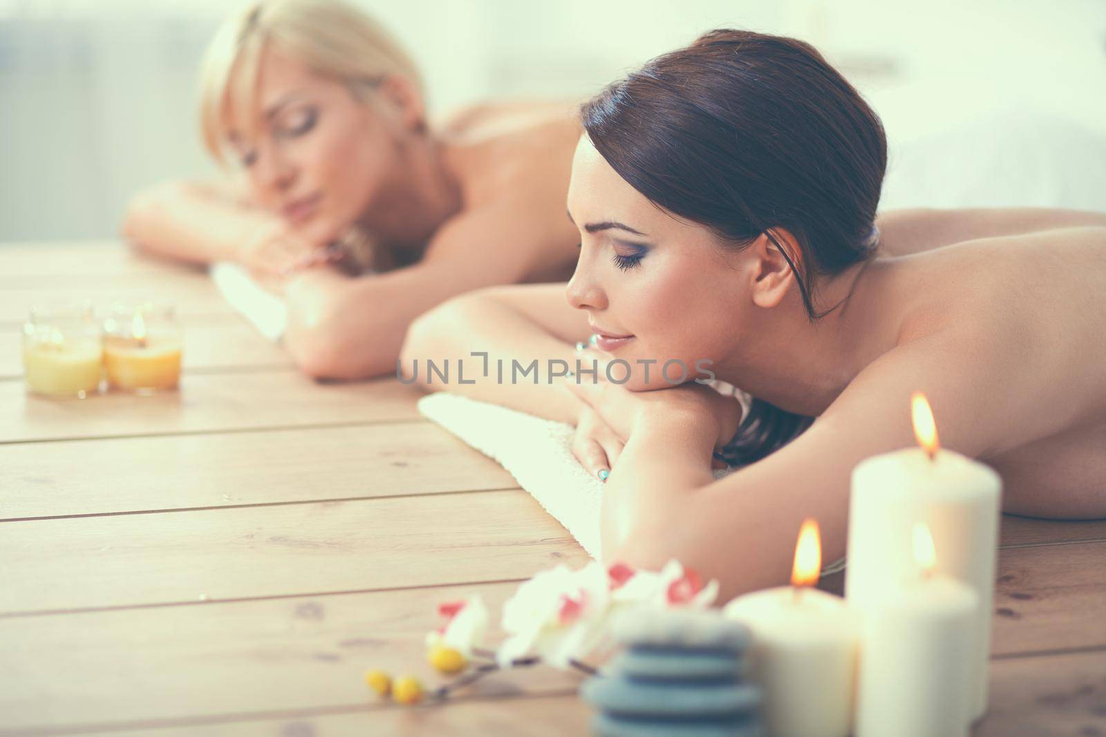 Two young beautiful women relaxing and enjoying at the spa cent by lenetstan