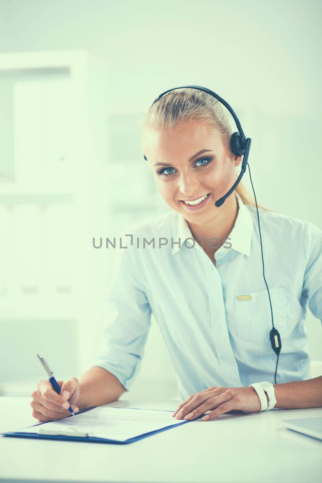 Close-up portrait of a customer service agent sitting at office.