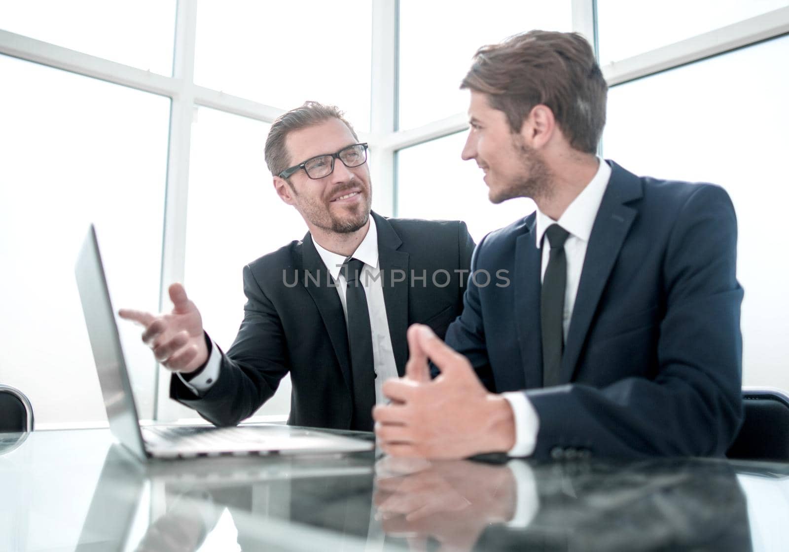 business partners sitting at the Desk.business and technology