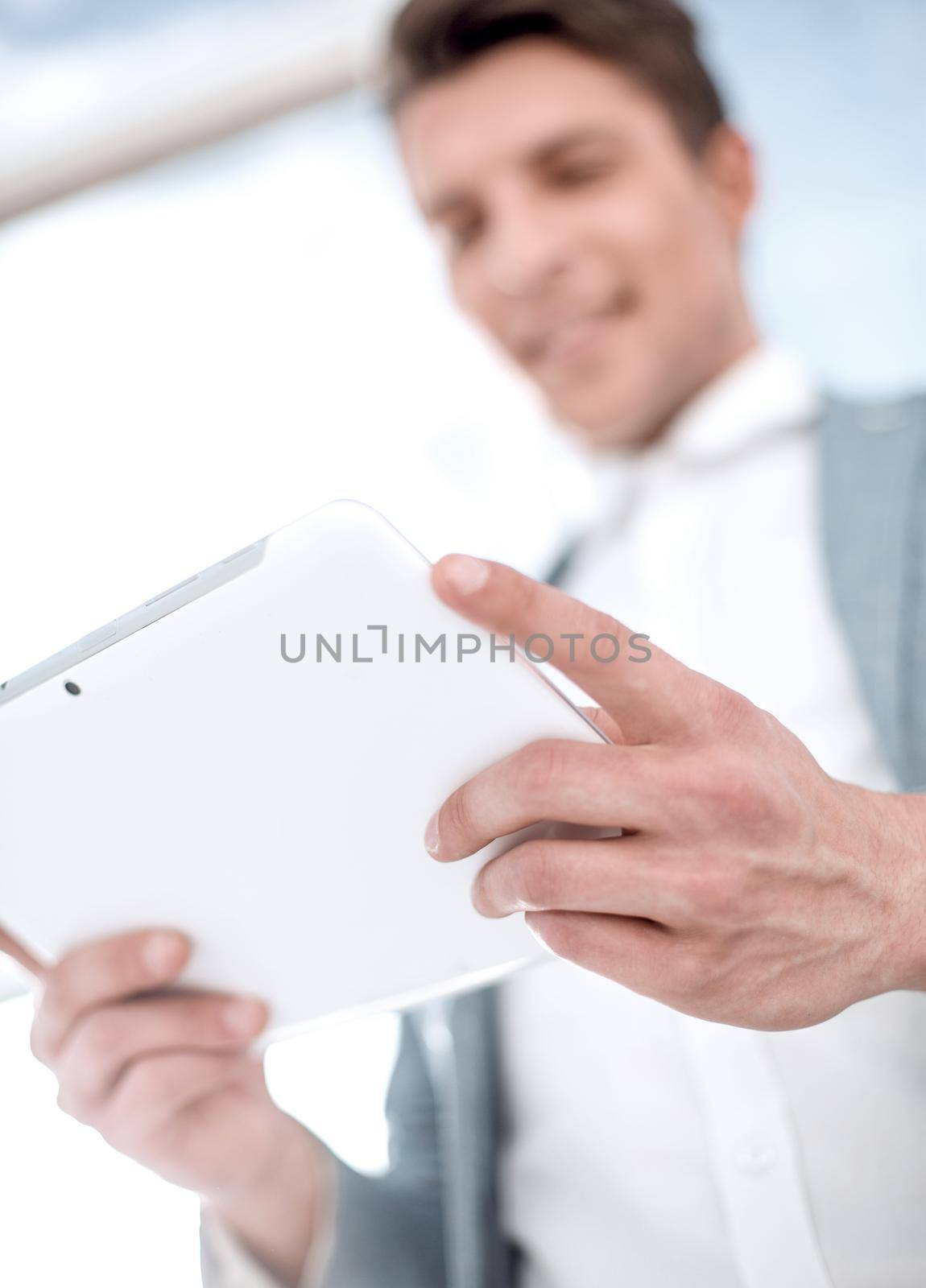close up.businessman looking at the digital tablet screen by asdf
