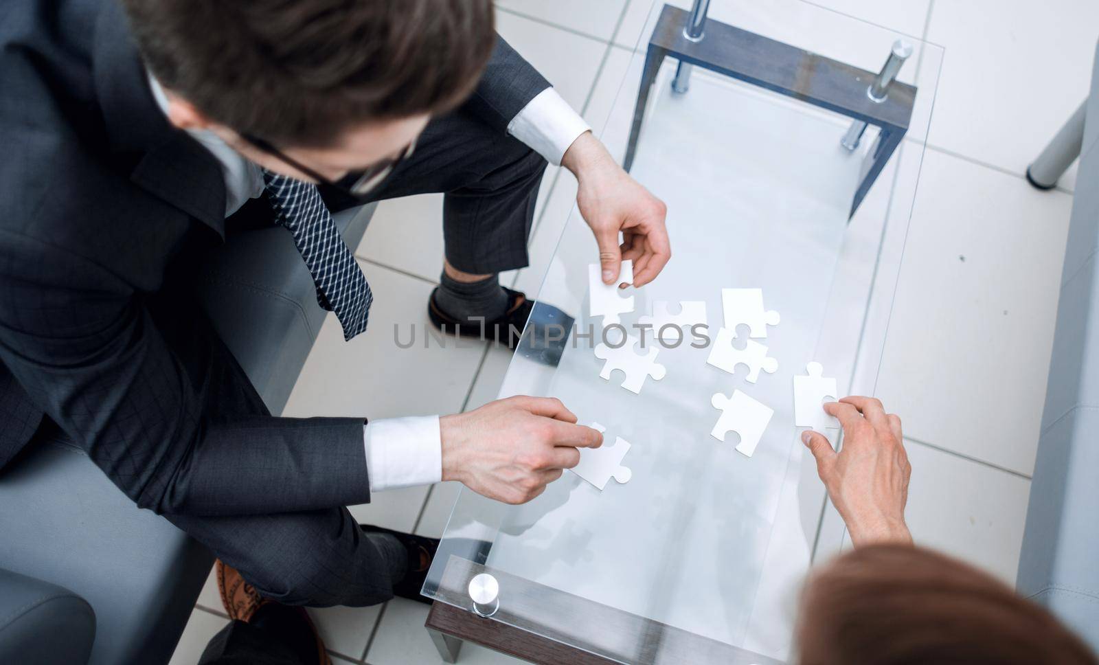 top view.business people collect puzzle.concept of partnership
