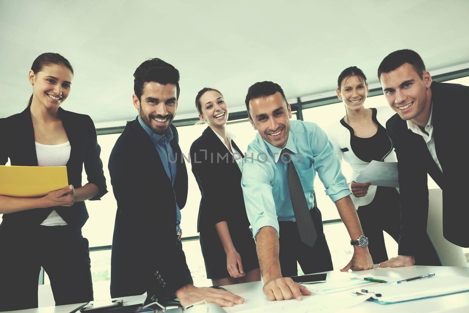 Group of happy young  business people in a meeting at office