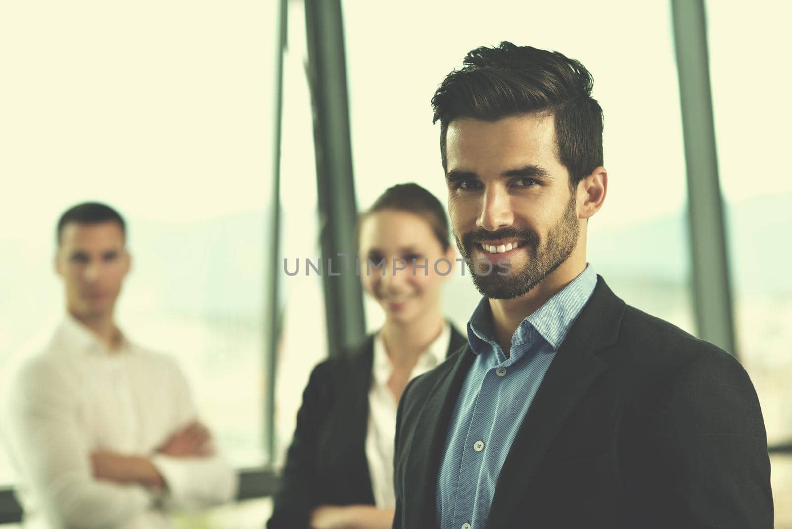 Group of happy young  business people in a meeting at office