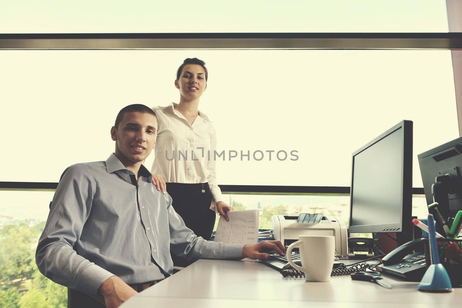 Group of happy young  business people in a meeting at office