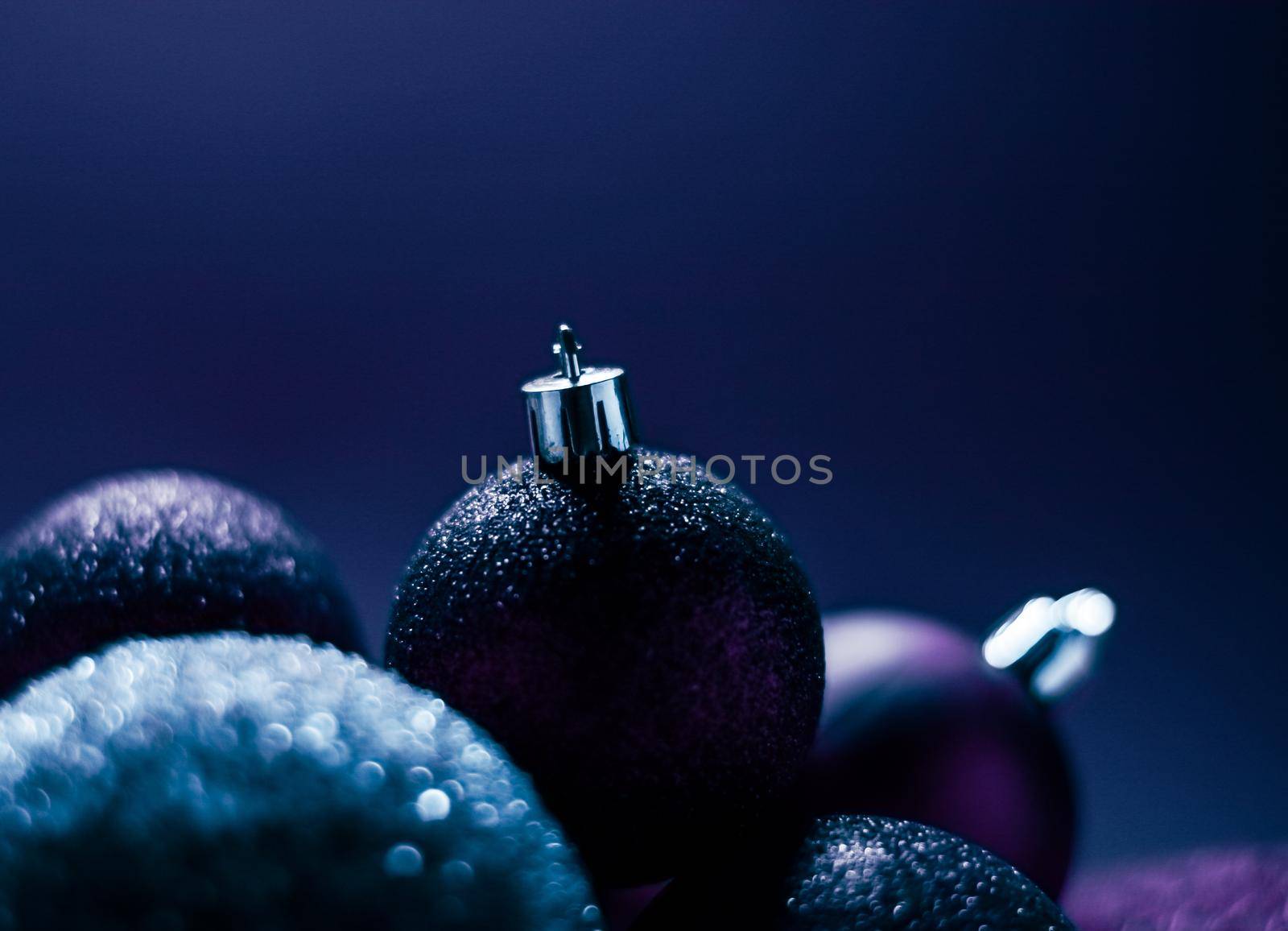 Purple Christmas baubles as festive winter holiday background.