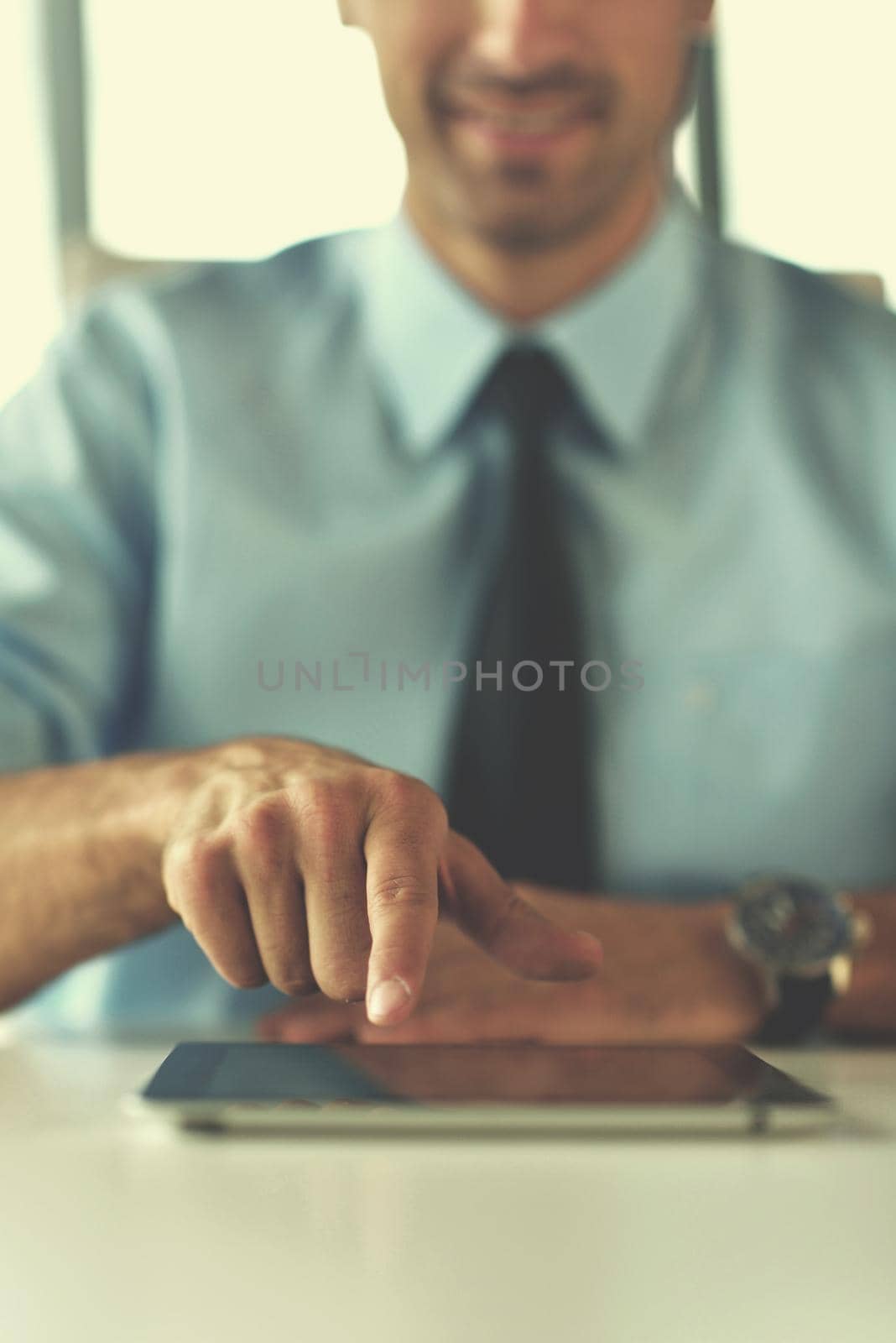 close-up of human hand  business man using tablet compuer at office