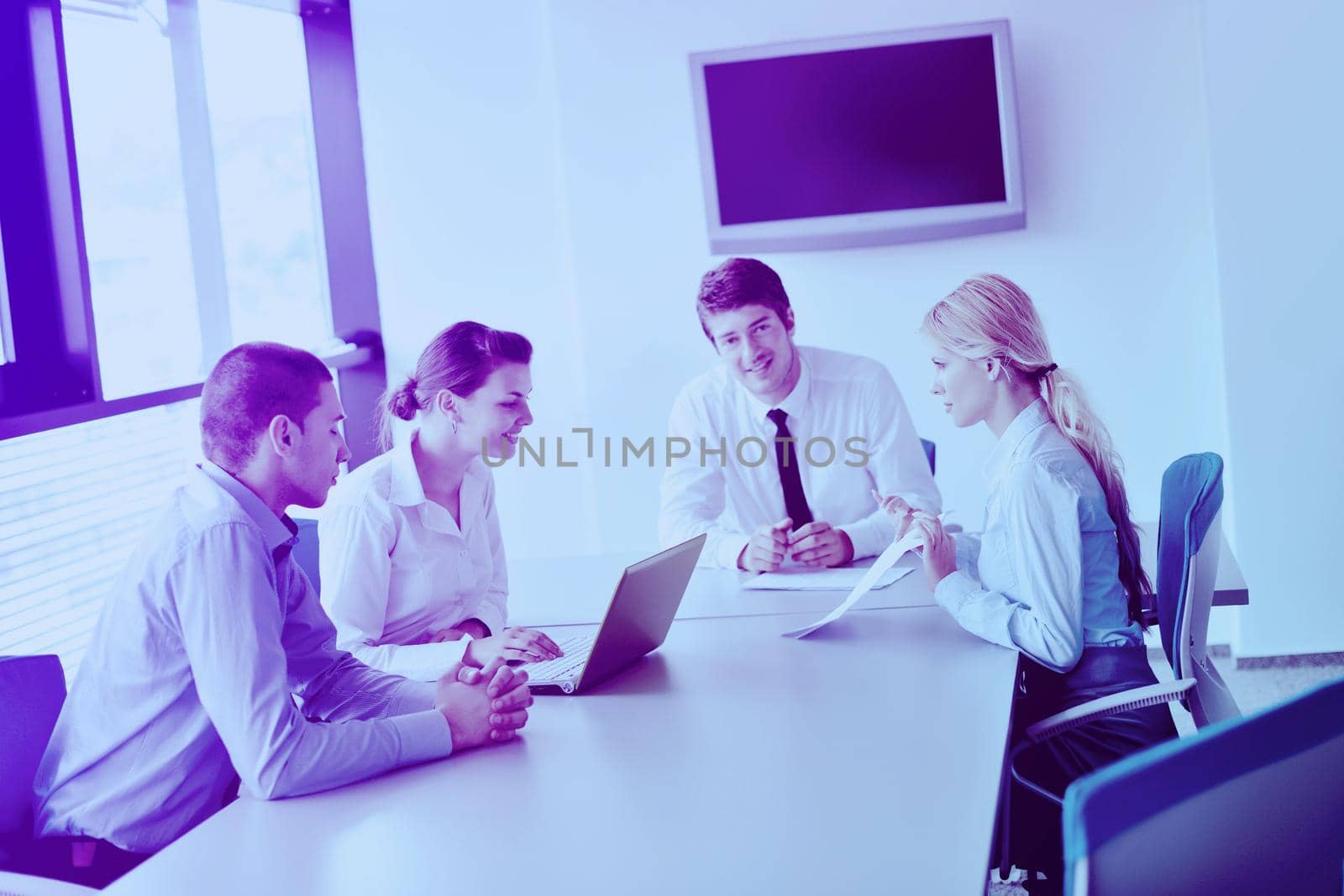 Group of happy young  business people in a meeting at office