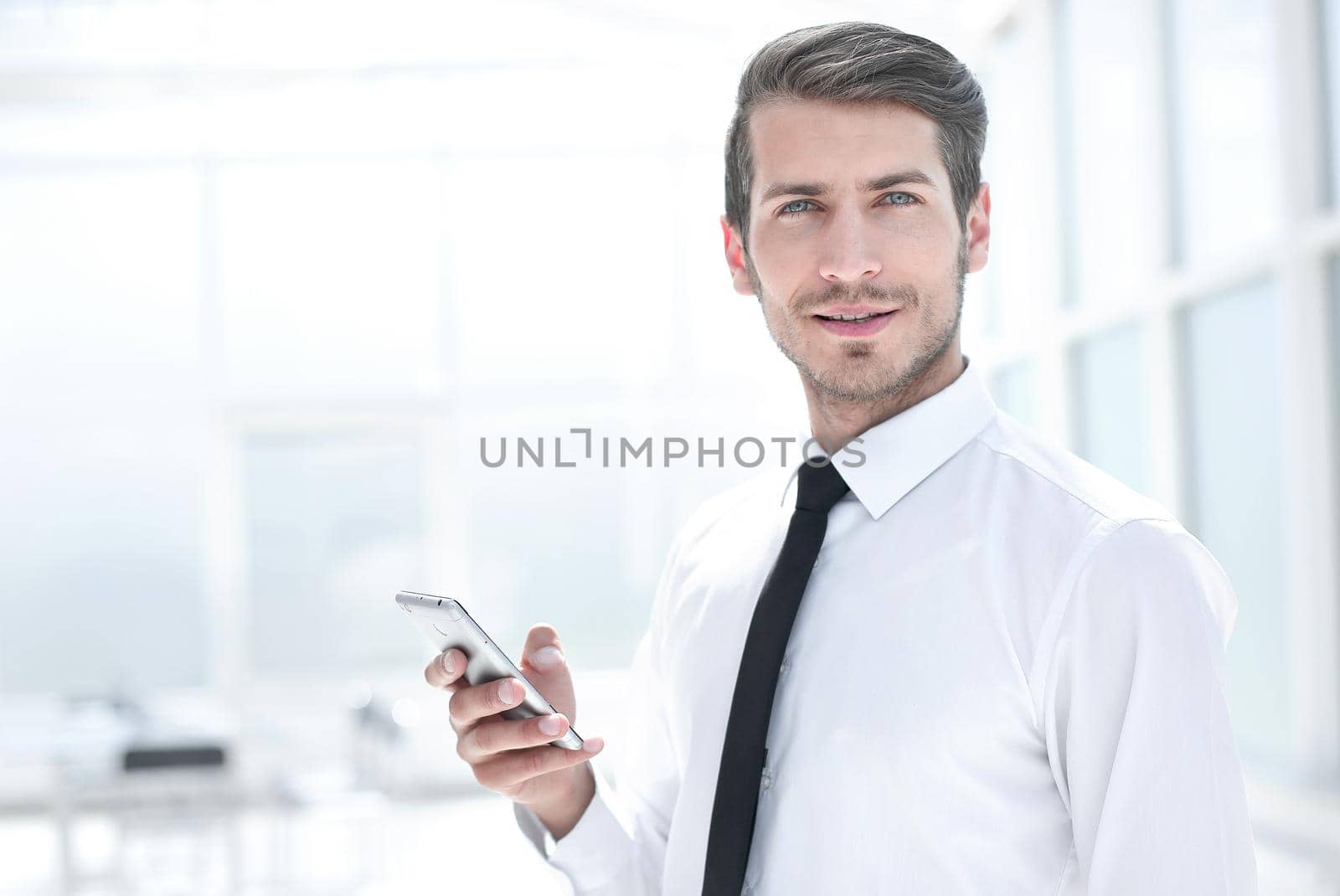 close up.smiling businessman with smartphone.business concept