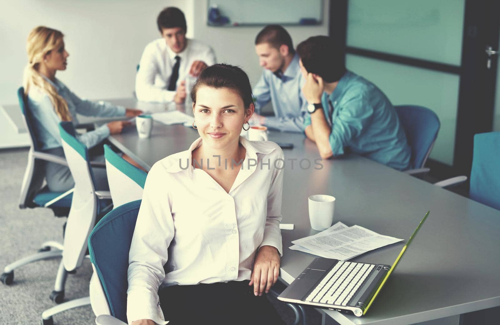 business woman  with her staff,  people group in background at modern bright office indoors