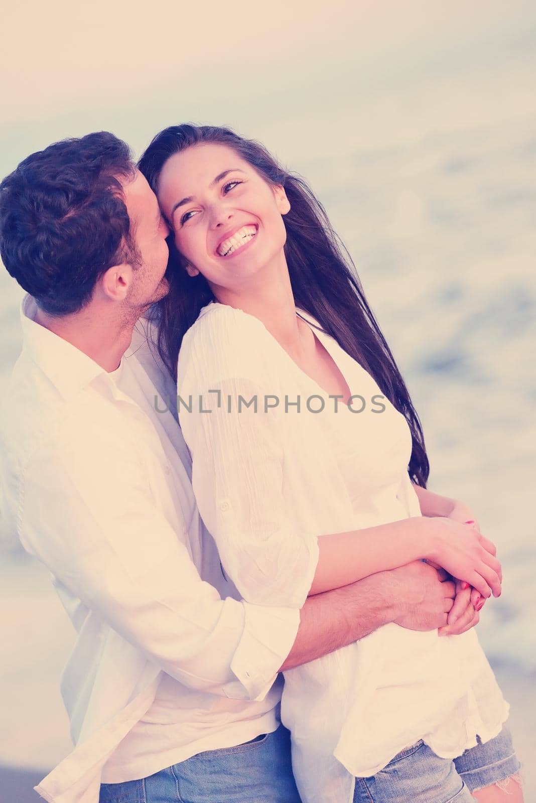 happy young romantic couple in love have fun on beautiful beach at beautiful summer day