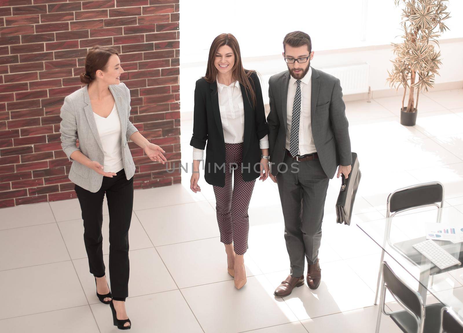 business people standing in a modern office by asdf