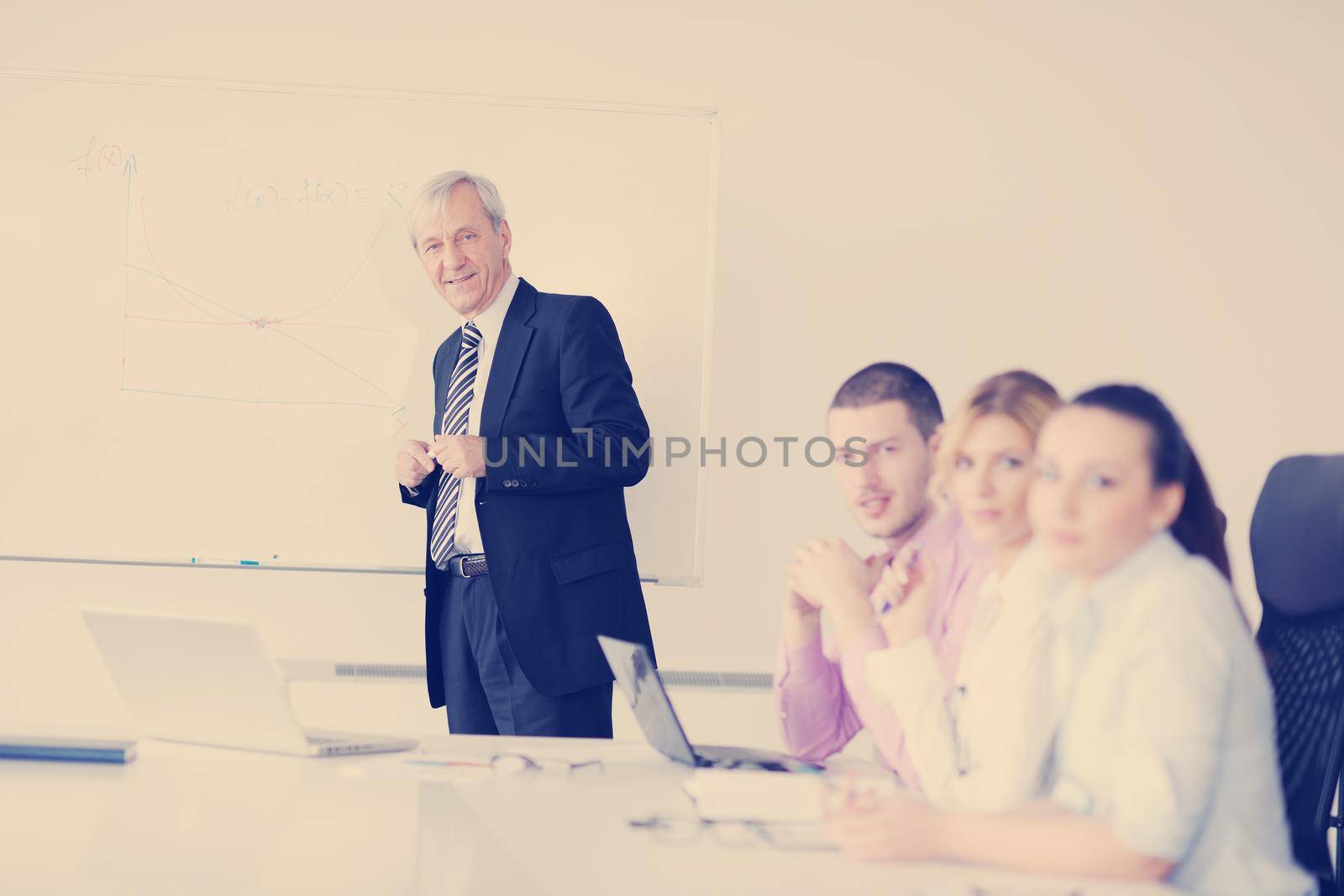 Senior business man giving a presentation by dotshock