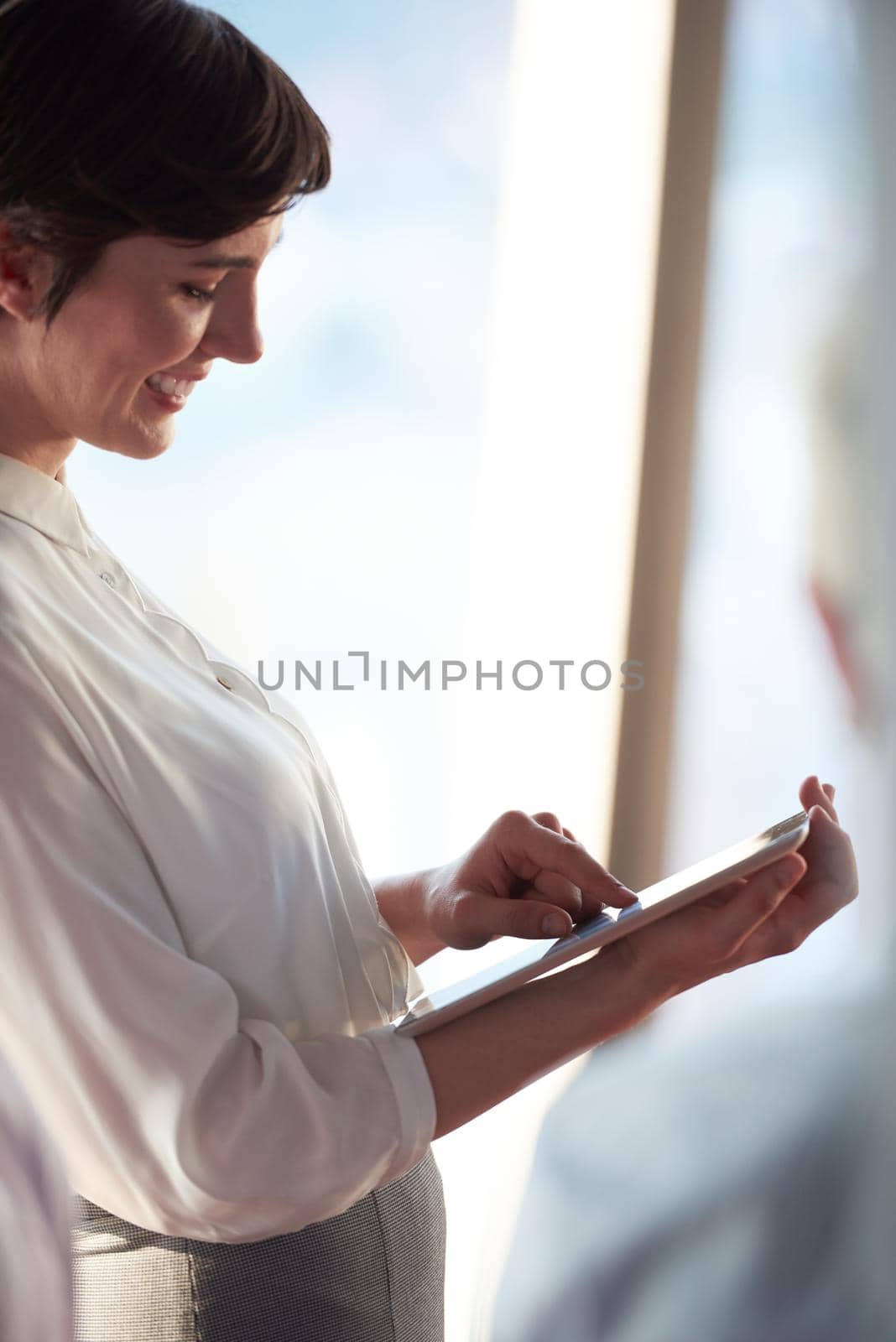 young business woman working on tablet computer at office