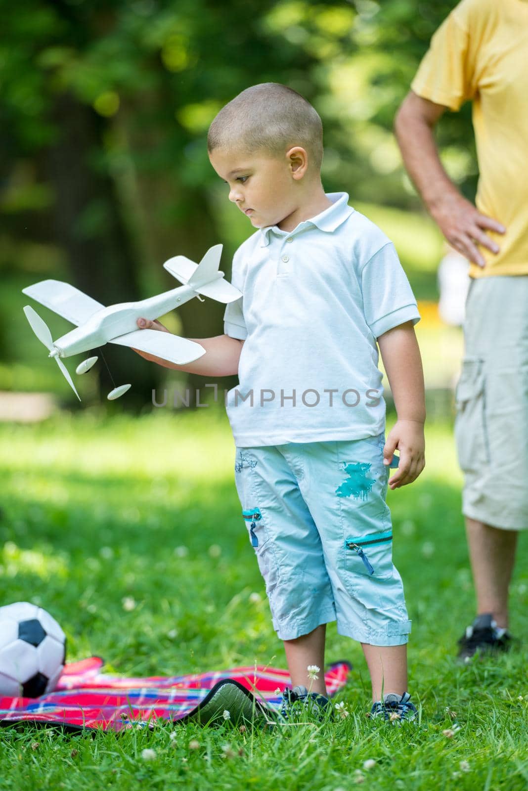 happy grandfather and child have fun and play in park on beautiful  sunny day