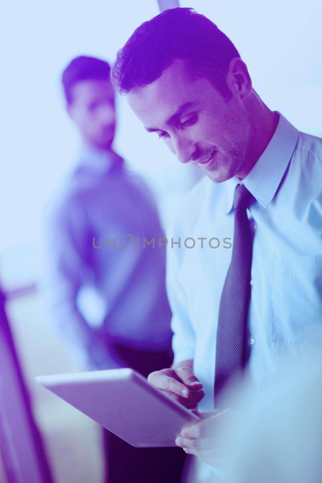 business man using tablet compuer at office by dotshock