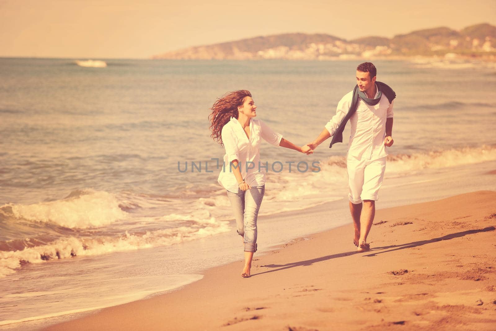 happy young couple in white clothing  have romantic recreation and   fun at beautiful beach on  vacations