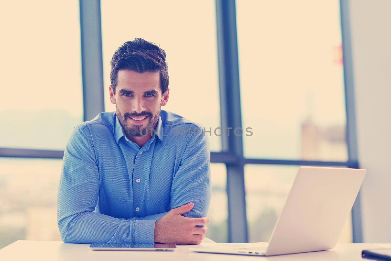 happy young business man at office by dotshock