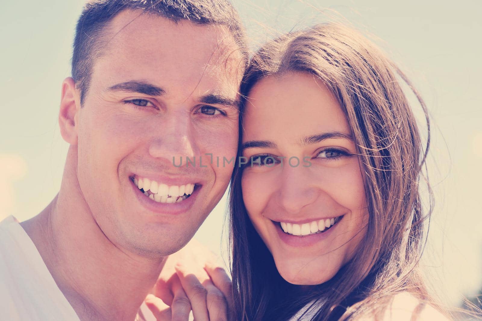 happy young couple have fun and relax  on the beach