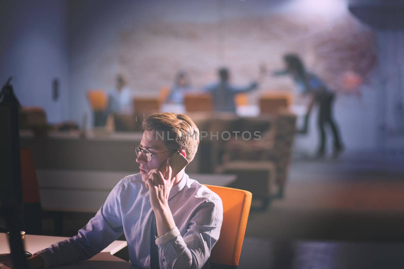 man using mobile phone in dark office by dotshock