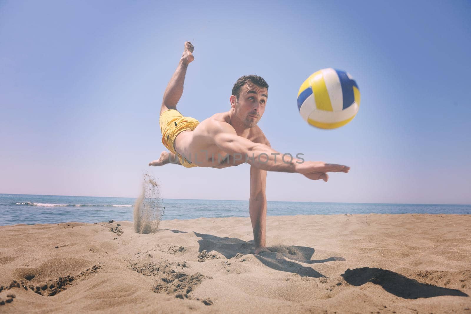 male beach volleyball game player jump on hot sand