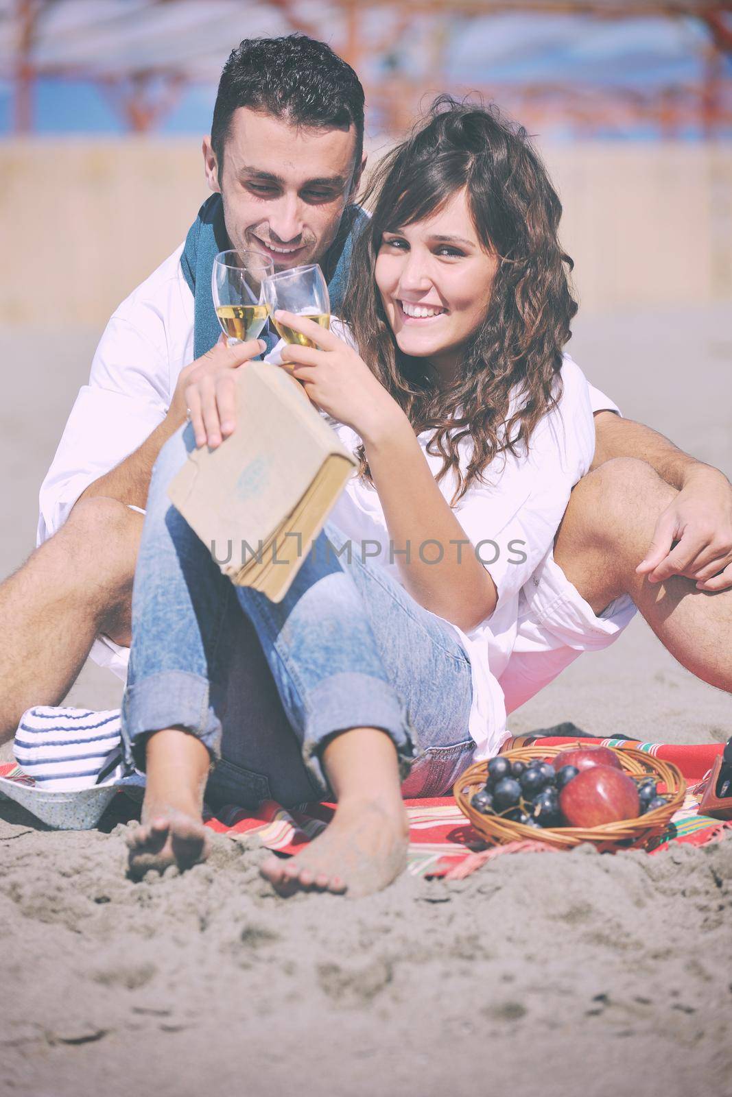 happy young couple enjoying  picnic on the beach and have good time on summer vacations