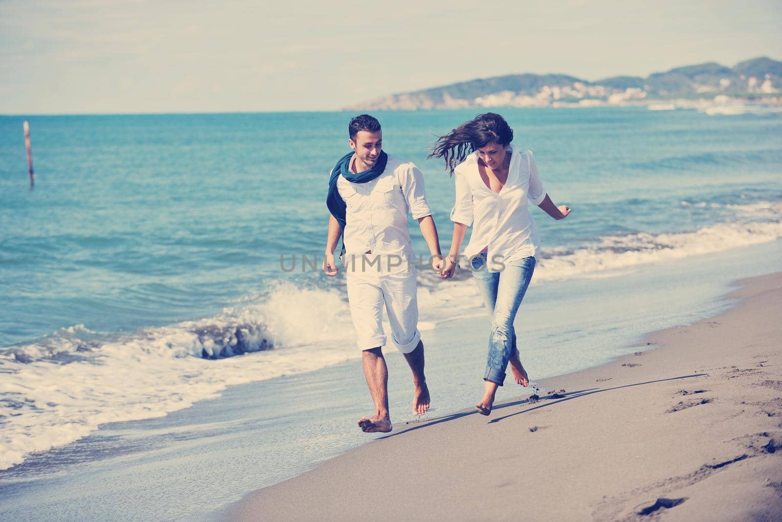 happy young couple in white clothing  have romantic recreation and   fun at beautiful beach on  vacations