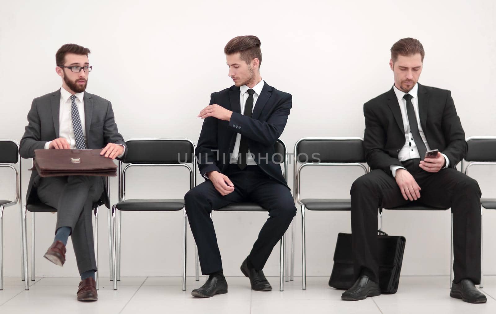 employees sitting on chairs in the hallway of the office.office weekdays