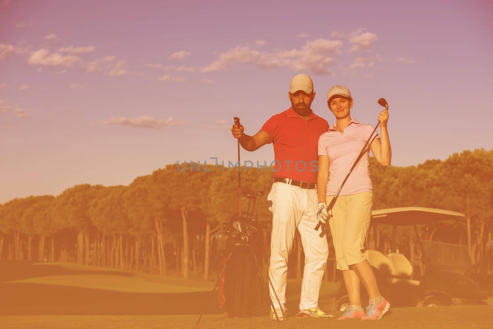 portrait of happy young  couple on golf course