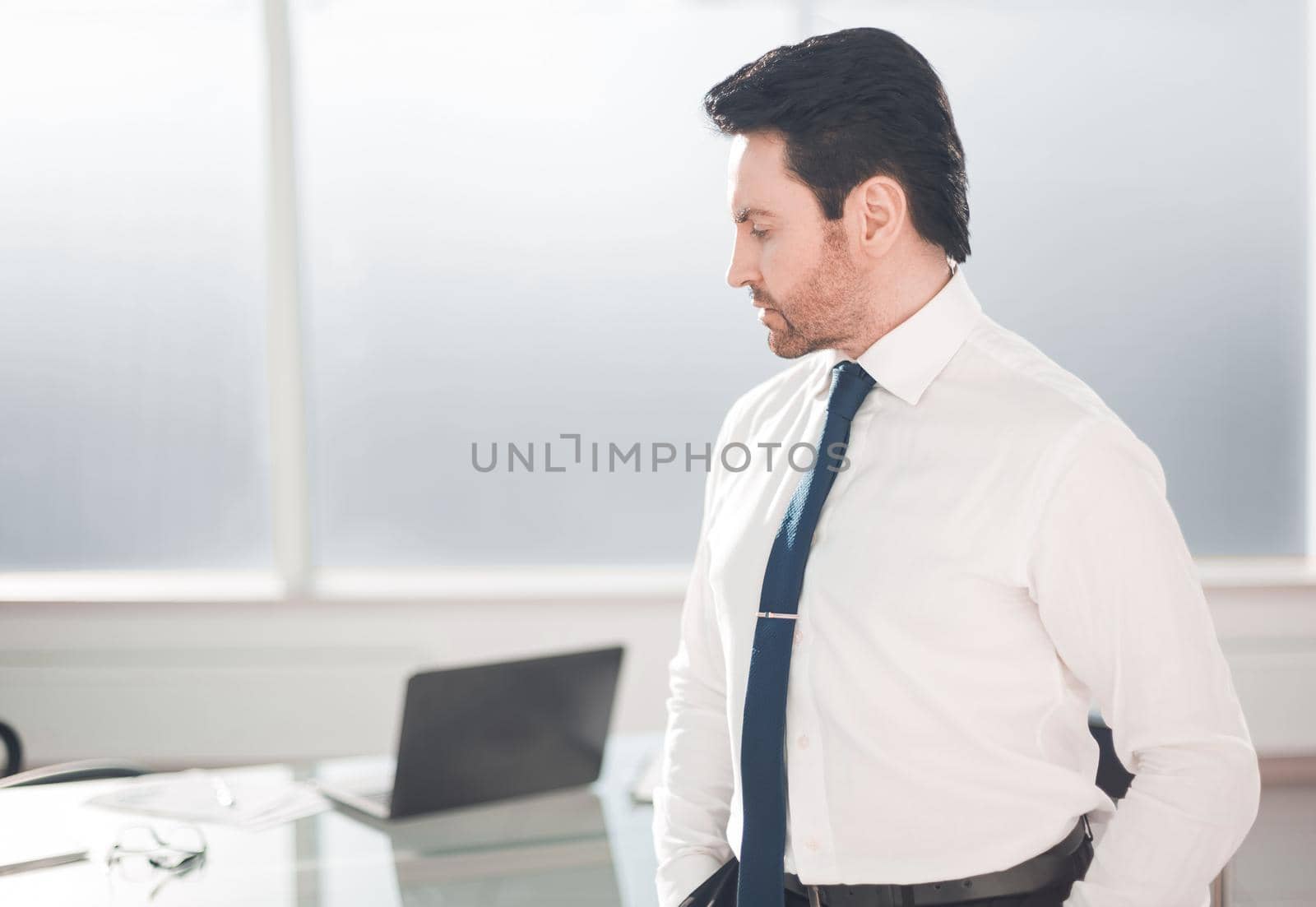 close up.serious businessman standing in the office.photo with copy space
