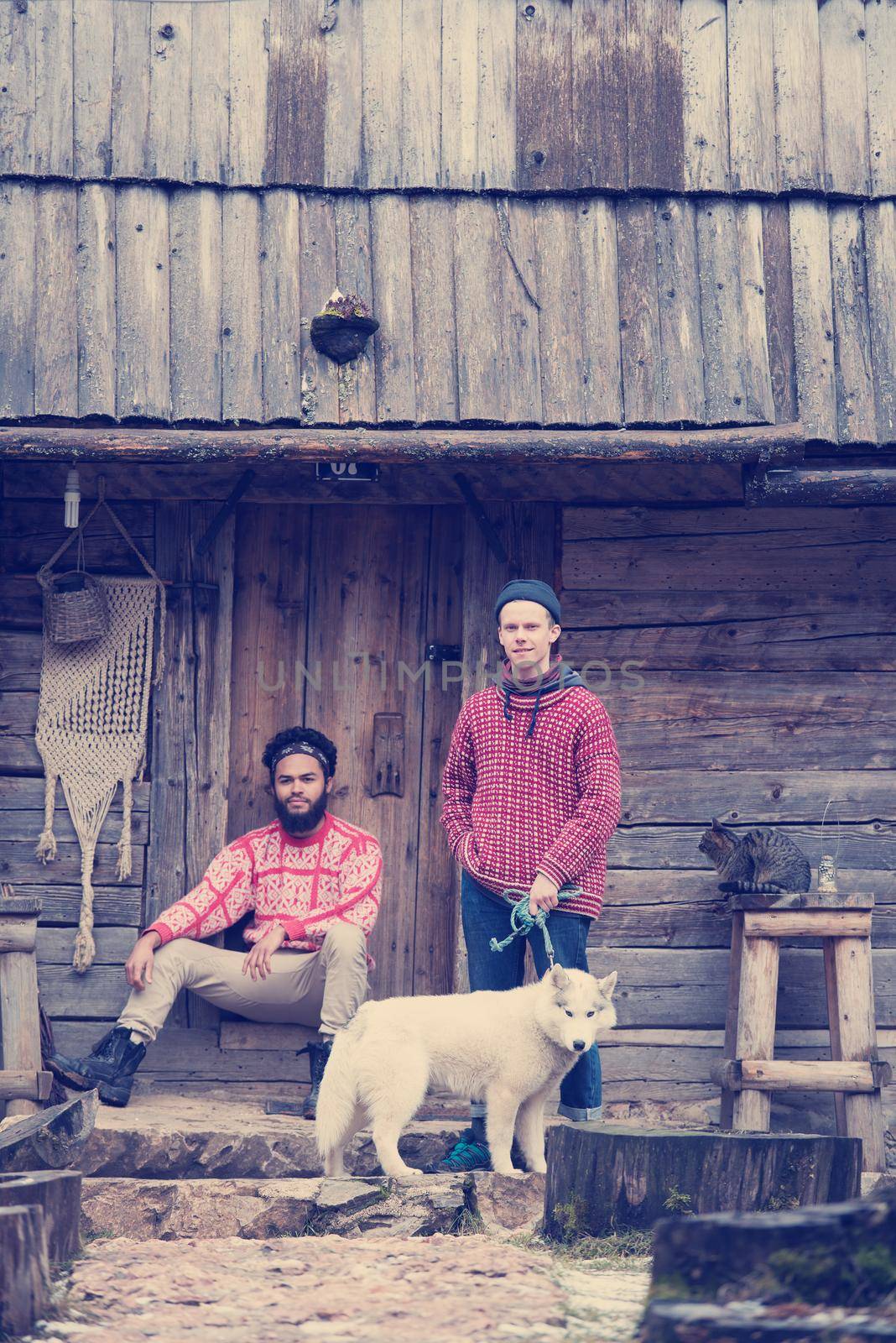 frineds together in front of old wooden house by dotshock