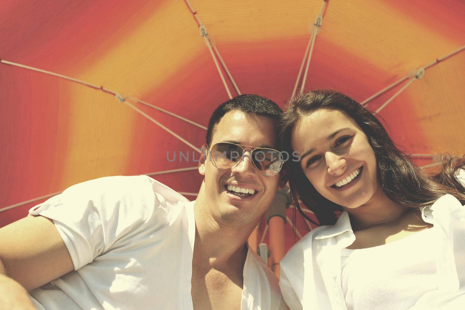 happy young couple have fun and relax  on the beach