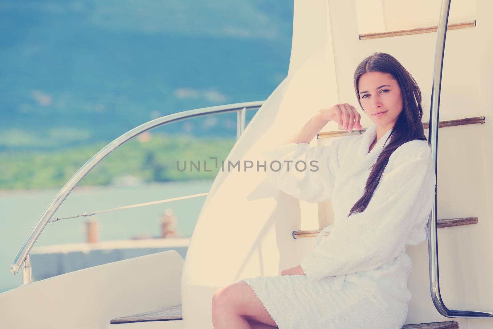 woman lies on a luxury yacht in the sea and looking to the horizon