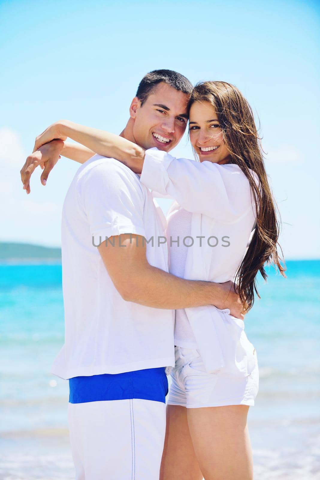 happy young couple have fun and relax  on the beach