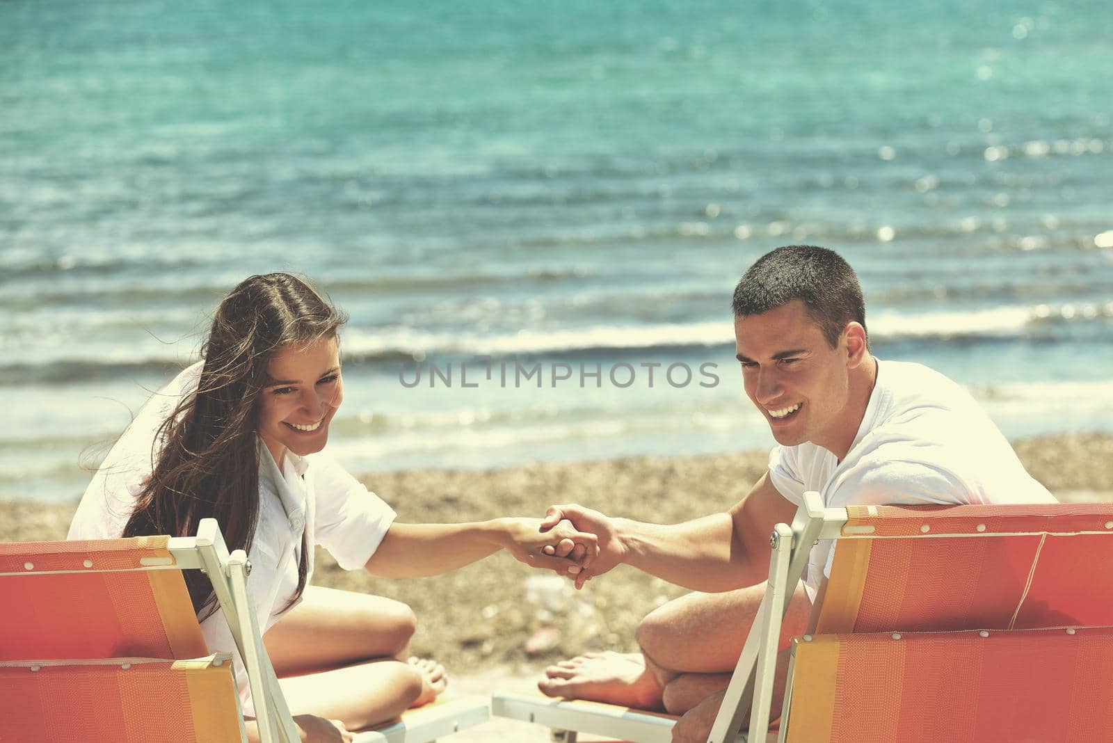 happy young couple have fun and relax  on the beach