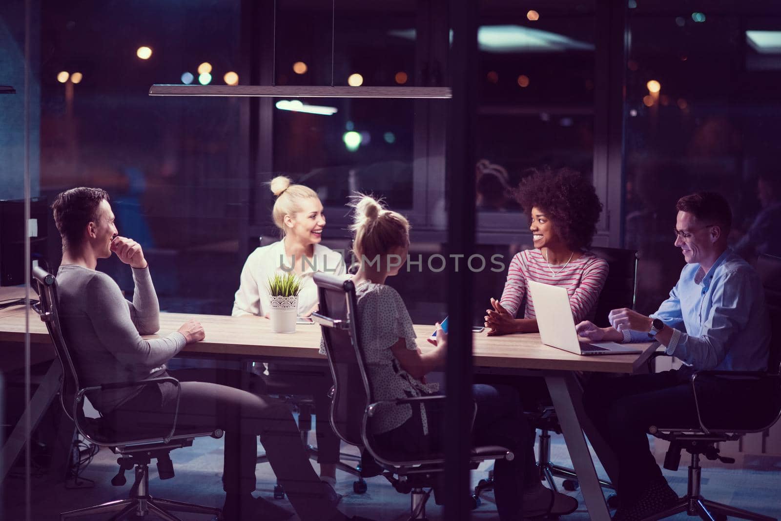 Multiethnic startup business team in night office by dotshock