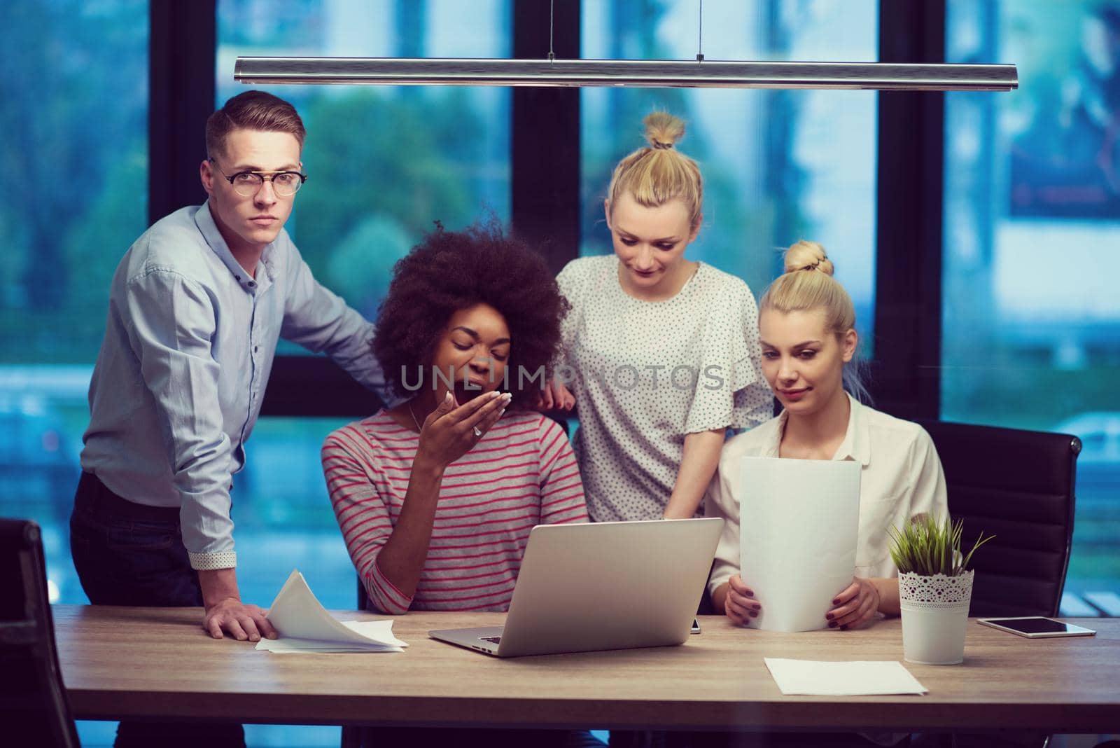 Multiethnic startup business team in night office by dotshock