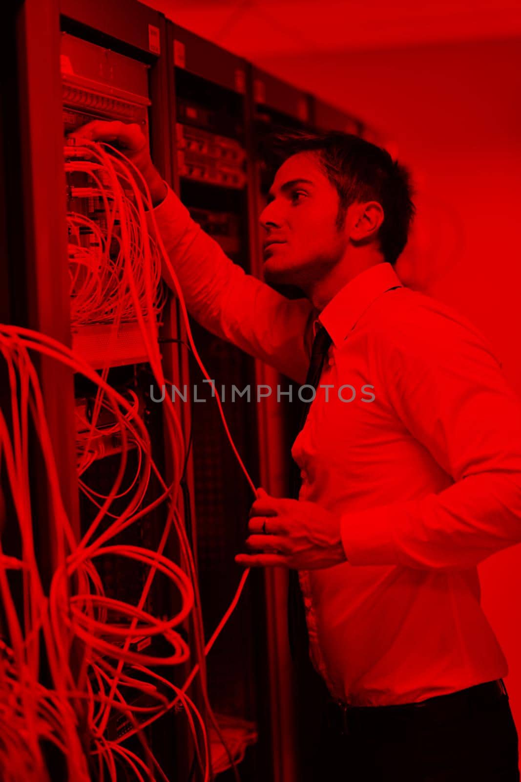 young handsome business man  engeneer in datacenter server room